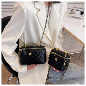 Detailed comparison of black quilted camera bags in medium and mini sizes with chain straps