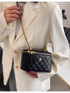 Classic black quilted bucket bag with gold chain strap and elegant floral logo detail