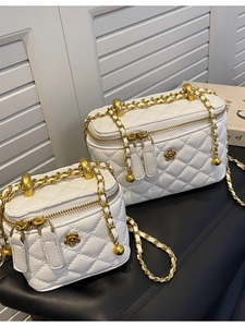 Quilted white leather bucket bags with gold flower clasp and chain straps in two sizes