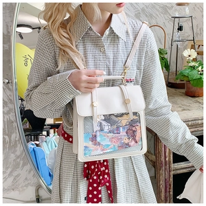 Detailed view of the clear PVC window and anime illustration on the white Ita bag