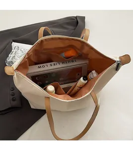 Detailed interior of a beige nylon tote bag showing spacious compartments and storage