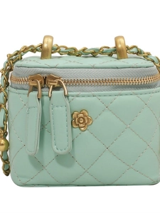 Chic mint green quilted bucket bag with gold chain strap and floral hardware