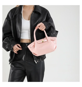 Close-up of pink wax leather bucket bag with pleated texture and gold square lock detail