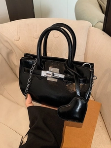 Glossy black shell handbag with silver hardware, metal chain strap and heart charm