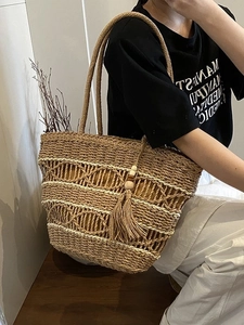 Large bohemian straw tote bag with tassel charm for summer vacation and beach trips