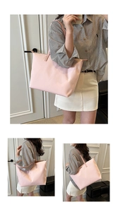 Detail view of large pink nylon tote bag showing minimal design and shoulder strap finish