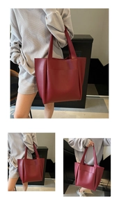 Detail of burgundy leather tote bag with large front pocket and long handles