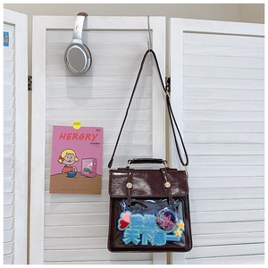 Detail of dark brown faux leather commuter bag with a transparent display window