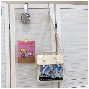 Detail of white ita bag showing transparent PVC window with anime illustration and PU leather texture