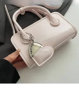 Detail of pink PU bowling bag featuring a heart charm and embossed CLEAROK logo