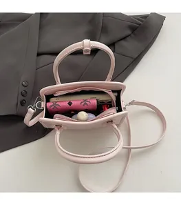 Internal view of the pink faux leather crossbody bag showing capacity for phone and wallet