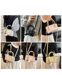 Multi-color PU leather bowling bag shown with detachable heart pendant and crossbody strap