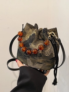 Elegant bucket bag with butterfly embroidery, beaded handle and drawstring tassel