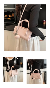 Detail of pink PU bowling bag showing the heart charm and adjustable shoulder strap
