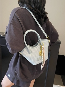 Light blue woven mini bucket bag with leather handles and detachable shoulder strap
