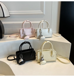 Four colors of mini PU bowling handbags featuring heart-shaped charms and crossbody straps