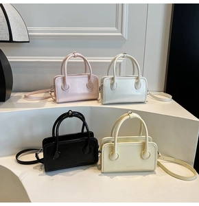 Detailed close-up of four solid color PU leather bowling bags in pink, white, black and yellow