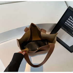 Detailed top view of brown tote bag showing magnetic closure and spacious interior