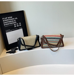 Detail of handwoven straw trapezoid bags with leather trim and colorful stripe textures