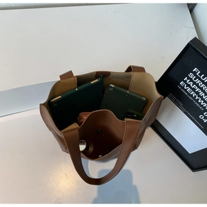 Top view of spacious brown leather tote bag interior showing tablets and cosmetics