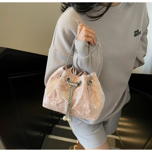 Pink jacquard bucket bag detail showing 3D floral embroidery and pearl drawstring