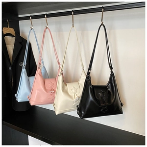 Detail showing collection of stylish faux leather handbags with embossed star patterns