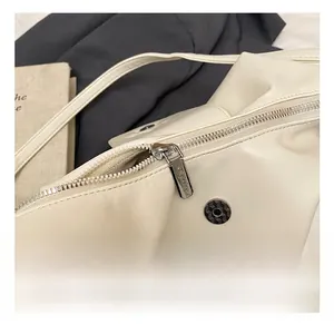 Detail showing polished gold hardware and leather texture of the large travel backpack