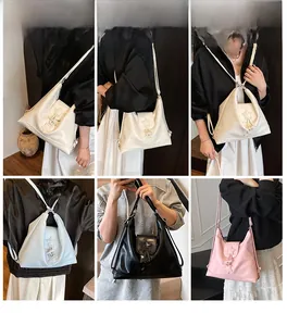 Fashion tote bag detail showing wide shoulder straps and star-shaped metallic ornaments