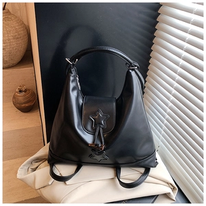 Detail of black PU leather tote with 3D star appliques and metal horn toggle closure