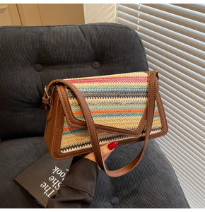 Detail of colorful rainbow straw woven crossbody bag with brown faux leather trim