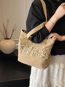 Retro washed denim tote bag in khaki with frayed letter patches and casual shoulder style
