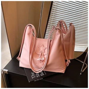 Detail of pink PU leather tote featuring star stitching and a white toggle button closure