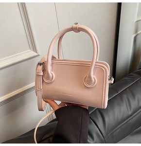 Detailed close-up of a pink faux leather handbag featuring a small CLEAROK logo and metal zipper