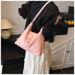 Detail of pink PU leather shoulder bag with star flap and matching star pendant