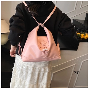 Pink lifestyle backpack with stars and horn buckle detail shown in a lifestyle scene