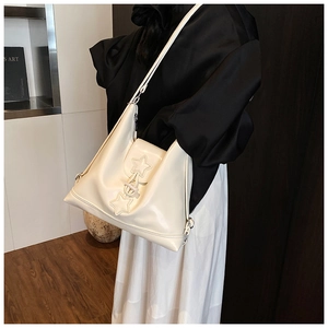 Minimalist beige tote bag featuring star studs and premium smooth faux leather texture