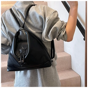 Detailed back view of a black matte PU backpack featuring 3D star accents and slim straps