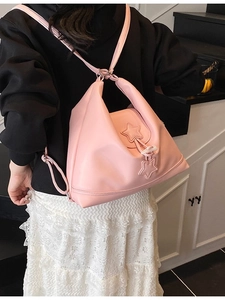 Pink PU leather fashion backpack for women with star charms shown on model in home setting