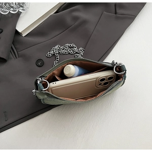 Internal view of denim crossbody bag showing space for phone and cosmetic items