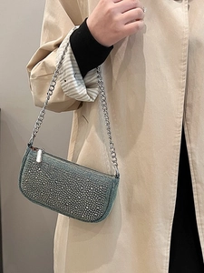 Blue denim saddle bag with silver rhinestones and chain strap shown on model