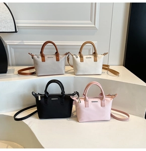 Detailed view of bucket bags in grey, beige, black and pink with adjustable shoulder straps