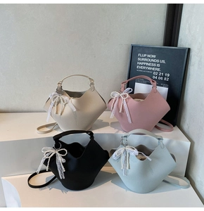 Detail of four bucket bags in cream, pink, black, blue with petal folds and pearl charms