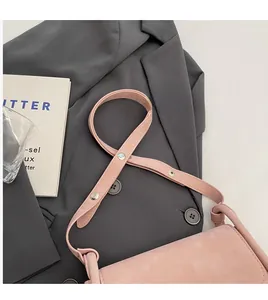 Detail of dusty rose crossbody bag with smooth leather strap and elegant matte finish
