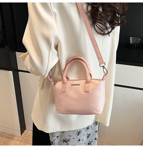 Pink PU leather bucket bag detail showing silver metal decor and detachable strap