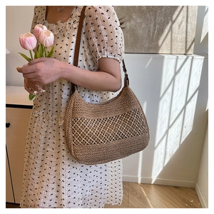 Brown woven shoulder bag with white diamond hollow pattern and leather strap detail
