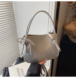 Detailansicht der silbernen Beuteltasche mit Bogenanhänger und Perlenriemen