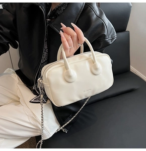 Detailed view of white PU leather bowling bag with embossed logo and silver chain strap