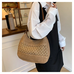 Detailed woven straw underarm bag with diamond hollow design shown in a cozy cafe setting