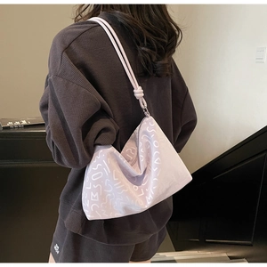 Vue détaillée du dos d'un sac fourre-tout violet clair avec bandoulière à nœuds chic