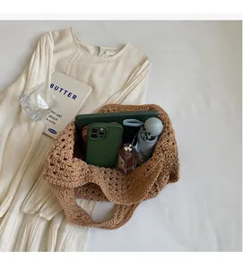 Detail of the brown hollow knit crochet shoulder bag showing large interior storage space